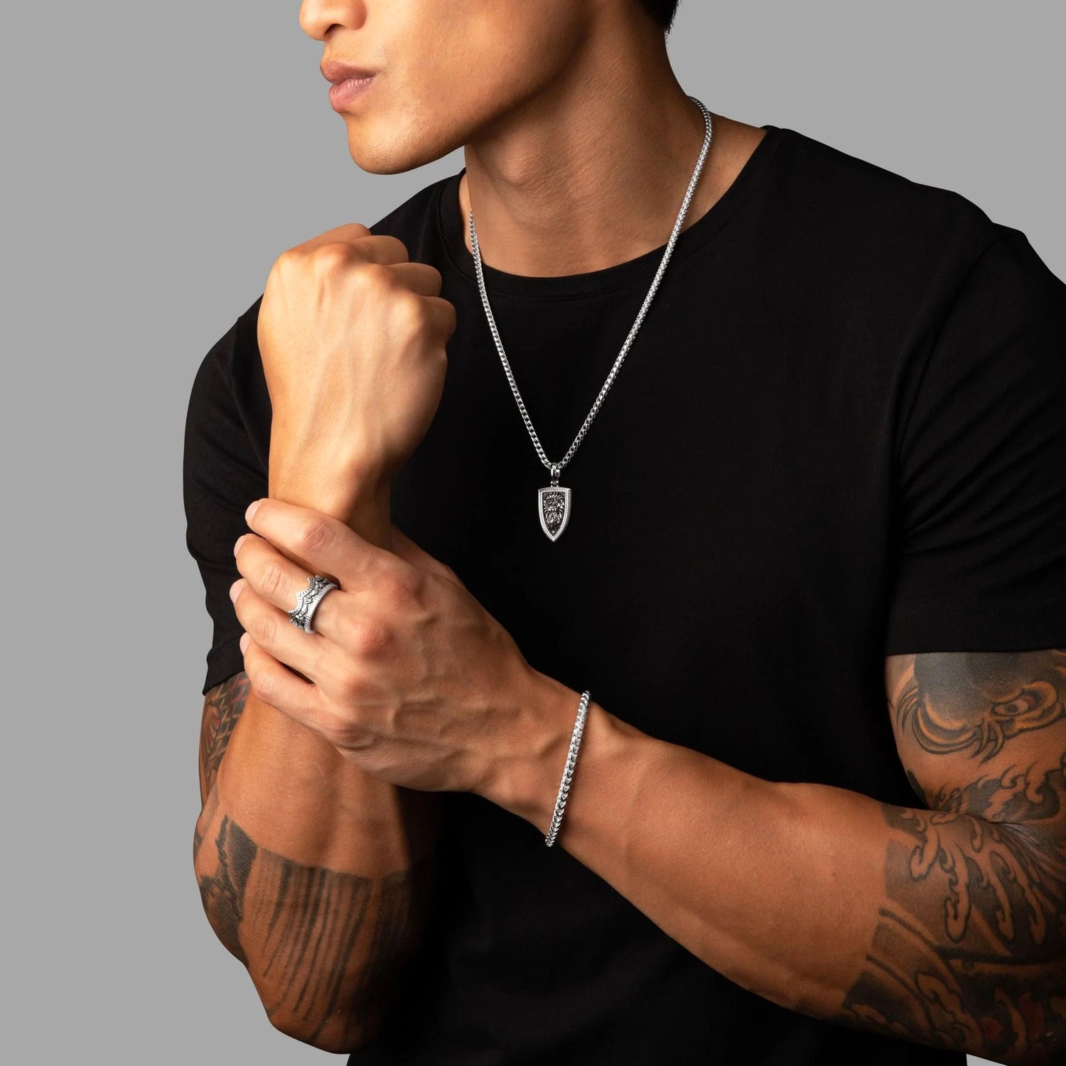 The Point — a clean, modern men's pendant, a single point of light.
